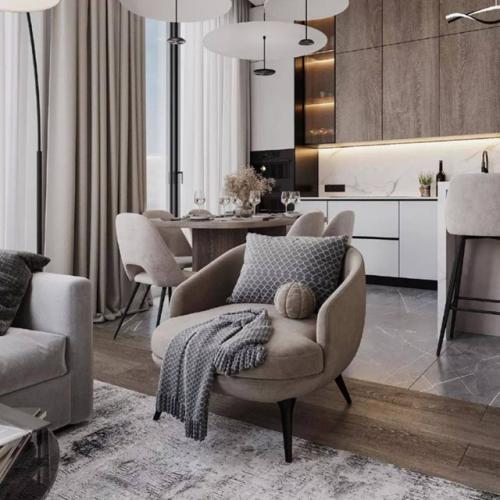 В интерьере этой кухни - гостиной, площадью 24 квадратных метров, отделка в светлых оттенках бежевого, серого и белого цвета. 03