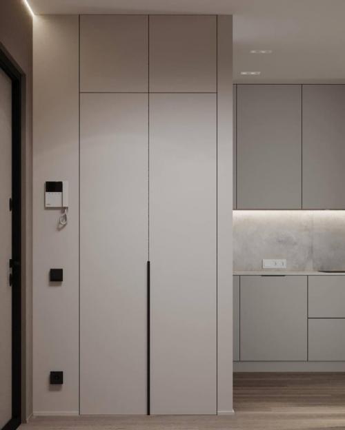 Интерьер лаконичной прихожей и кухни - гостиной площадью 26 квадратных метров в светлом исполнении. 08